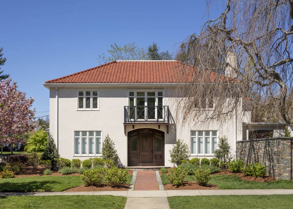 Blackstone Boulevard Mediterranean Home exterior with stucco facade, red tile roof, and arched entry