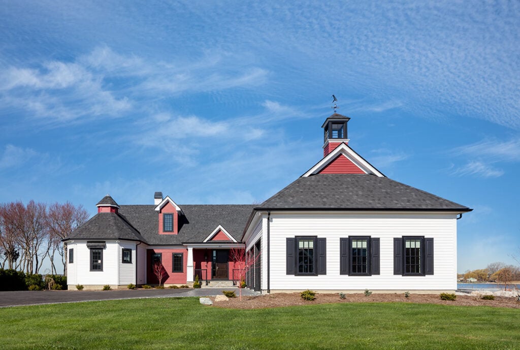 Warwick Neck Custom Home exterior with white siding, red barn-style entry, and cupola