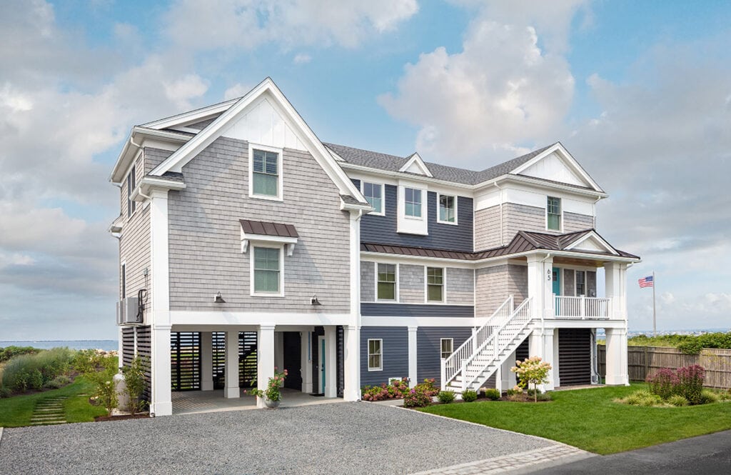 Point Judith Waterfront custom home with gray shingles, elevated deck, and coastal landscaping