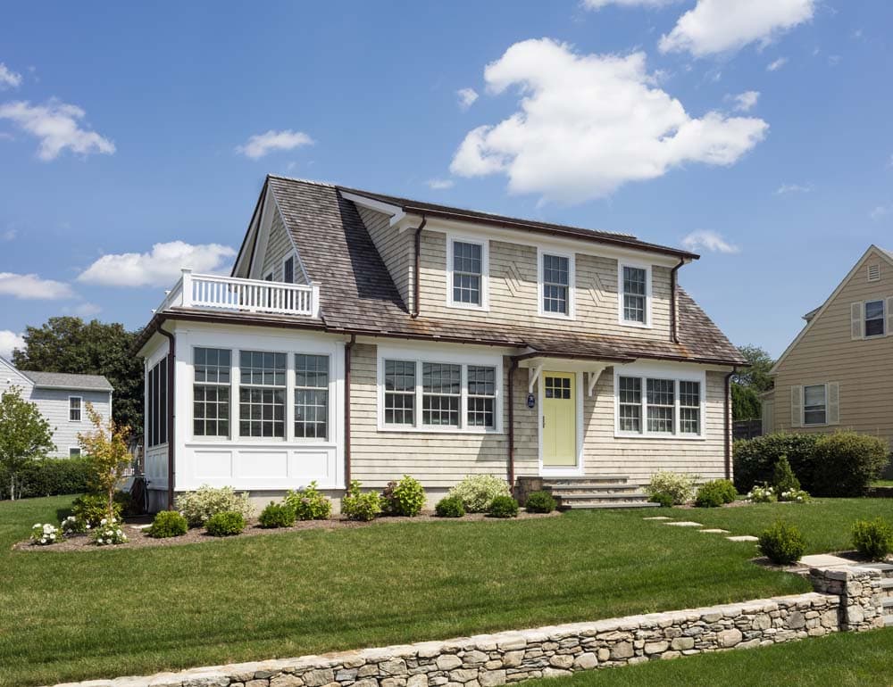 Bonnet Shores Beach Home exterior remodel with raised home, new siding, and wraparound deck