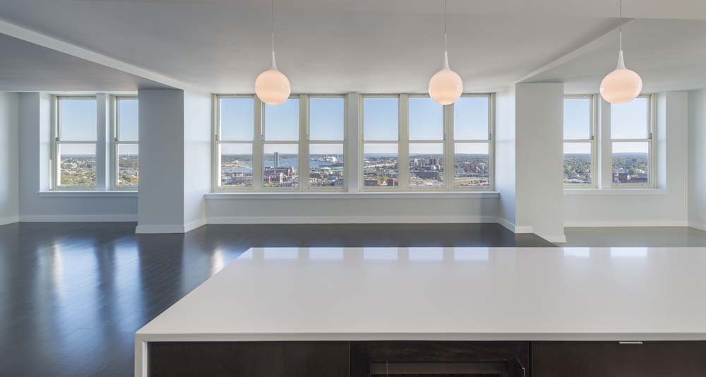 Providence 32nd Floor Penthouse interior with large windows, city views, and pendant lighting