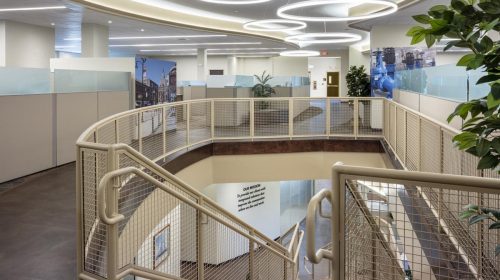 Interior office stairwell with modern railings and decorative ceiling lighting, Deslandes Construction Inc.