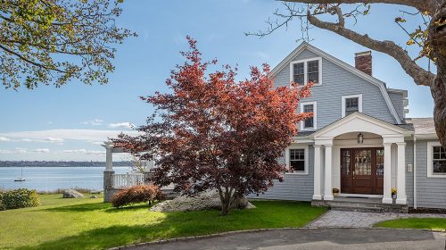 Warren Waterfront home exterior with gray shingle siding, covered entry, and bay views