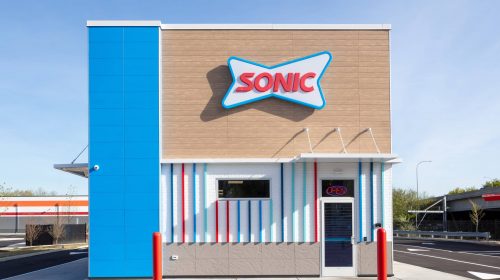 Modern Sonic drive-thru building with vibrant blue, red, and white exterior, showcasing professional commercial construction by Deslandes Construction Inc.
