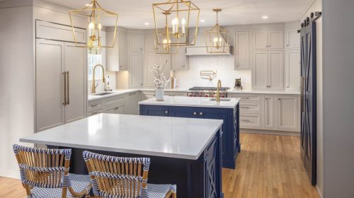 Westerly Retreat kitchen remodel with white cabinetry, blue island, and pendant lighting
