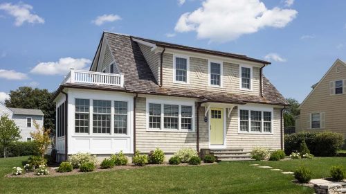Bonnet Shores Beach Home exterior remodel with raised home, new siding, and wraparound deck