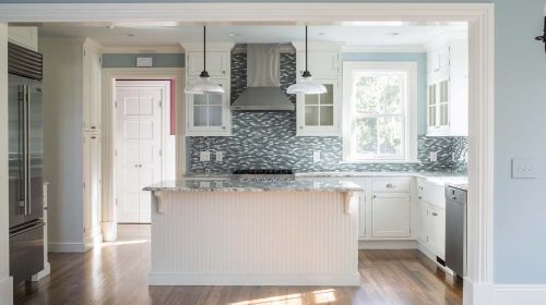 Barrington 1800’s Farmhouse kitchen renovation with granite countertops, tiled backsplash, and white cabinetry
