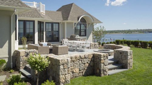 Edgewood Eclectic Cape renovation with stone patio living area and waterfront views